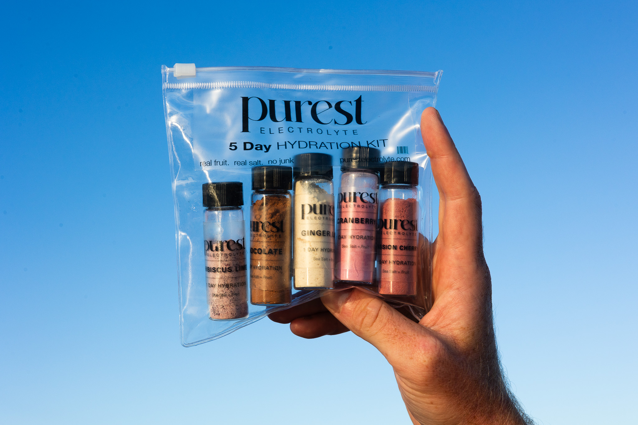 Purest Electrolyte five day hydration kit with naturally colored powders visible in clear glass vials